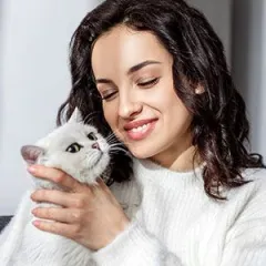 woman hugging her cat